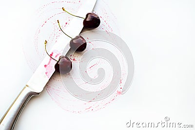 The knife cuts the cherry. Stock Photo