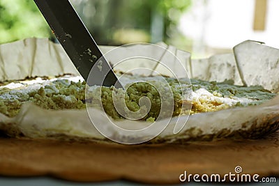 a knife cuts a piece from a shortbread pie Stock Photo