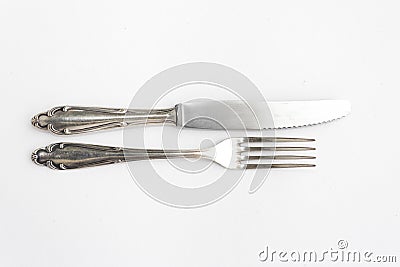 Knife, fork, fancy silver cutlery on white Stock Photo