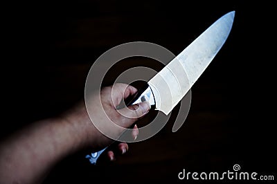 Knife in hand Stock Photo