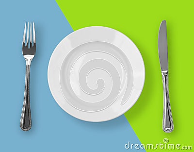 Knife, plate and fork on color backdrop top view Stock Photo