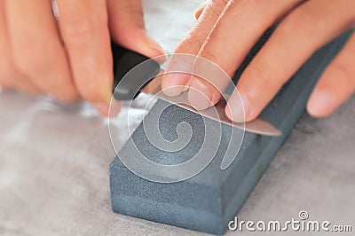 Knife sharpening, blade, whetstone Stock Photo