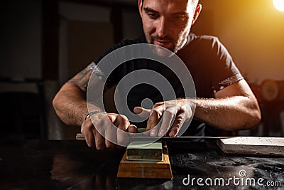 Knife sharpening concept Stock Photo