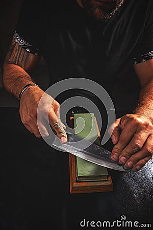 Knife sharpening process. Stock Photo