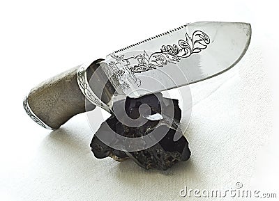 Knife and Tourmaline cristall Stock Photo