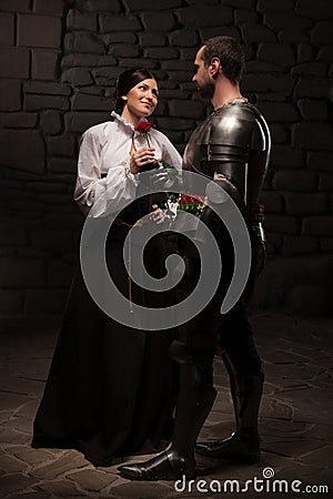 Knight giving a rose to lady Stock Photo