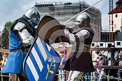 Knight tournament. The knights in the congregations are fighting in the ring. Public event in the city. Editorial Stock Photo