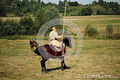 Knight tournament. Medieval armored riders with lances on horses. Equestrian soldiers are in the field Editorial Stock Photo