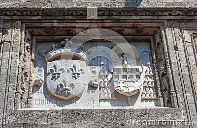 Knightly coat of arms on the wall of a house in Rhodes. Stock Photo