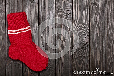 Knit red wool socks on dark wooden background. Stock Photo