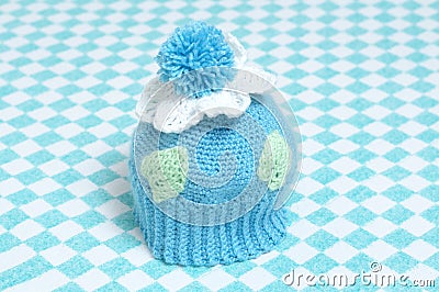 Knitted cap for babies with pompon Stock Photo