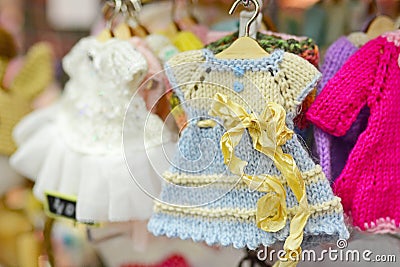 Knitted doll dress on a hanger Stock Photo