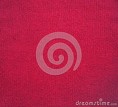 Knitted fabric texture. Red color. Garter stitch with facial loops. Knitting on the knitting needles. Knitted background Stock Photo