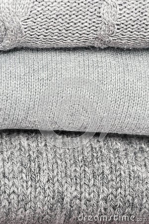 Knitted products from gray wool stacked close-up. Stock Photo