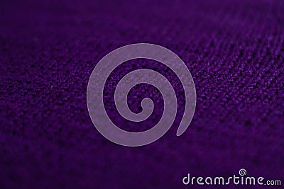 Knitted sweater with small braid, plain purple background Stock Photo