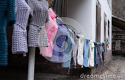 Knitted woolen things hanging on a rope Stock Photo