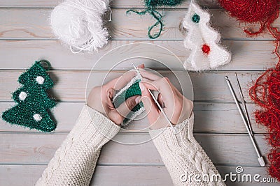 Knitting Christmas gifts handmade. Making knitted New Year decoration. Top view. Stock Photo