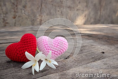 Knitting hearts with Millingonia on wooden table Stock Photo