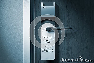 A knob of a hotel door with `Please do not disturb` tag Stock Photo