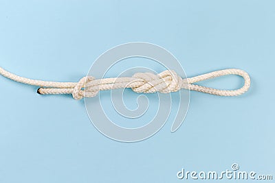 Knot Ð°igure-eight loop with stopper knot on blue background Stock Photo