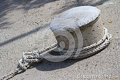 Knot of the rope on the bollard closeup. Stock Photo