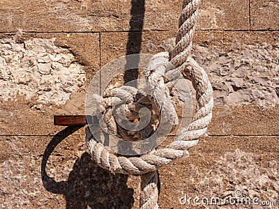 Knot on a thick rope tied to an oarlock front view Stock Photo