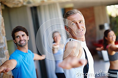 They know their workouts will pay off. A yoga class in progress. Stock Photo