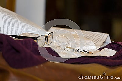 Book, pencil and a pair of glasses Stock Photo