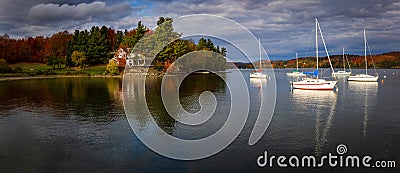 the Knowlton-Landing wharf, on Lake Memphremagog in the Eastern Townships in the fall. some sailboats are moored there Editorial Stock Photo