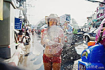 KO SAMUI, THAILAND - APRIL 13: Unidentified girl shooting water at the camera in a water fight festival or Songkran Festival Editorial Stock Photo