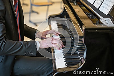 19.03.2021 Koblenz Germany - Male Hand playing on schimmel piano at party Event dinner Close-up Small depth of field Stock Photo