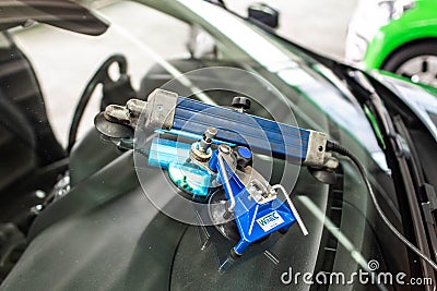 Koblenz Gerrmany 04.04.2018 man using repairing equipment to fix damaged cracked windshield at wintec company Editorial Stock Photo