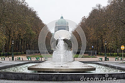 Koekelberg, Brussels Capital Region, Belgium - View over a city fountain, a colorful tree lane and the Basilica of the Editorial Stock Photo