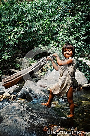 kogi tribal kid doing laundry in the nearby stream close to their home Editorial Stock Photo
