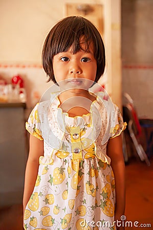 Portrait of a Khmer little girl in vintage dress, cute black eyes looking at camera Editorial Stock Photo