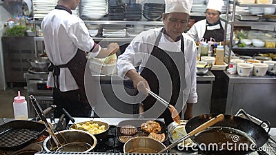 Koh Samui, Thailand, 20 may april 2018. Professional chef cooks cutlets with mashed potatoes on a pan. Cook works in a Editorial Stock Photo