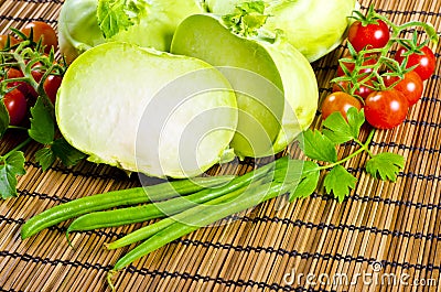 Kohlrabi, tomatoes and young peas Stock Photo