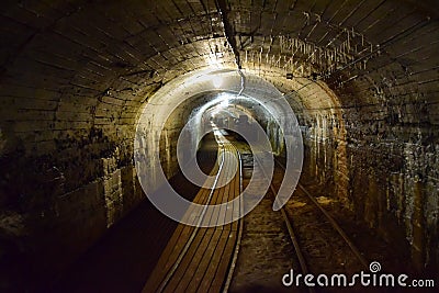 The mine is a museum, the dark tunnel through which the rails Editorial Stock Photo
