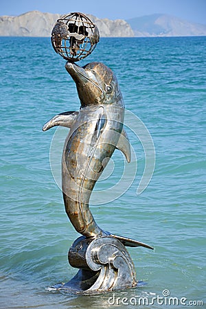 KOKTEBEL, CRIMEA â€“ MAY 28, 2019: Dolphin statue at Koktebel beach Editorial Stock Photo