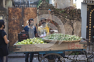 Kolkata, India -02.04.2020: Local Indian vendor selling fresh assorted green vegetables in the van during lock down period in Editorial Stock Photo