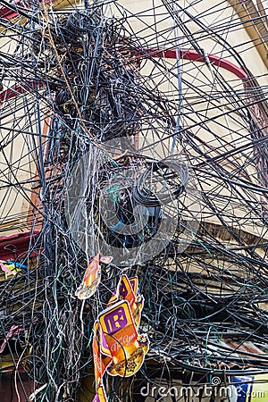 KOLKATA, INDIA - OCTOBER 31, 2016: Chaotic mess of wires in the center of Kolkata, Ind Editorial Stock Photo