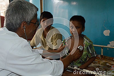 A paediatrician is checking a little boy with stethoscope. Editorial Stock Photo