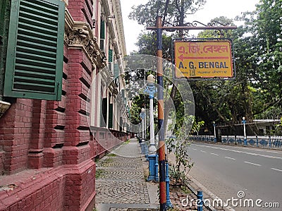 Rusted metal street sign board placed on the pole outside the British era colonial buildings in Calcutta. Editorial Stock Photo