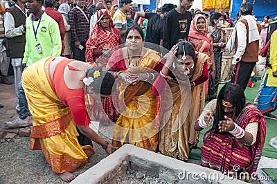 The Hindu devotees are busy in a holy ritual in front of a Homa Kund. Editorial Stock Photo