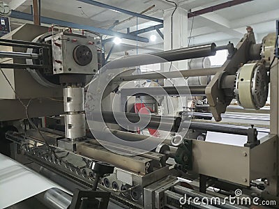 Extruder and roller running for coating polyethylene , PE on paper, for making Editorial Stock Photo