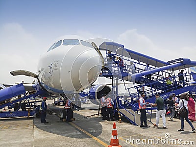 Passengers are boarding Indigo flight at Kolkata air port. Blue sky and white cloud Editorial Stock Photo