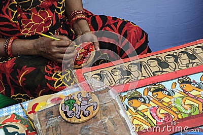 A woman artist painted on a earthen pot in a handicraft fair. Editorial Stock Photo