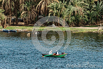 KOM OMBO EGYPT 19.05.2018 fishermen in a boat on the Nile river in the city of Kom Ombo Editorial Stock Photo