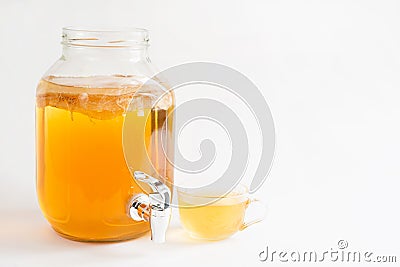 Kombucha-a drink made from tea mushroom in a glass jar with a tap. Transparent mug with a yeast drink made from a Japanese Stock Photo