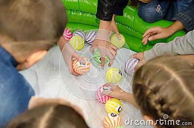 Children collect ball with letters to make words out of them Editorial Stock Photo
